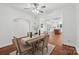 Spacious dining room with a wooden table, complemented by hardwood floors and an open view of the modern kitchen at 545 Dilworth Mews Ct, Charlotte, NC 28203