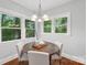 Cozy dining room featuring a wooden round table, surrounded by white chairs, and complemented by lots of natural light at 545 Dilworth Mews Ct, Charlotte, NC 28203