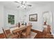Lovely dining room featuring a wooden table with chairs, an elegant orchid centerpiece, and decorative artwork on the wall at 545 Dilworth Mews Ct, Charlotte, NC 28203
