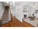 Inviting entryway with a staircase, hardwood floors, and a view of the cozy living room with a fireplace at 545 Dilworth Mews Ct, Charlotte, NC 28203
