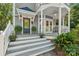 Inviting front porch and stairs featuring decorative plants, sconce lighting, and a painted teal front door at 545 Dilworth Mews Ct, Charlotte, NC 28203