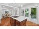 Kitchen featuring an island with a cooktop, light countertops, and access to the backyard at 545 Dilworth Mews Ct, Charlotte, NC 28203