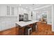 Spacious kitchen featuring stainless steel appliances, white cabinetry, and a large island with seating at 545 Dilworth Mews Ct, Charlotte, NC 28203