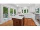 Bright, updated kitchen with stainless appliances, a center island with gas cooktop, and white cabinetry at 545 Dilworth Mews Ct, Charlotte, NC 28203