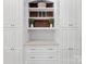 Custom white cabinetry with display shelves, drawers, and cabinets for storage and organization at 545 Dilworth Mews Ct, Charlotte, NC 28203