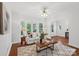 Bright living room with a white sofa, hardwood floors, a decorative rug, lots of natural light, and an open layout at 545 Dilworth Mews Ct, Charlotte, NC 28203