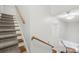 Staircase with carpeted steps and wooden handrail leading to upper level at 545 Dilworth Mews Ct, Charlotte, NC 28203