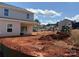 Image of backyard with unfinished landscaping. Construction vehicles on site at 5626 Skinny Dr, Charlotte, NC 28215