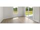 Light-filled bedroom with a window and sliding glass door that allow access to the outside at 5626 Skinny Dr, Charlotte, NC 28215