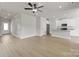 Open-concept living room featuring hardwood floors and ample natural light, great for entertaining at 5626 Skinny Dr, Charlotte, NC 28215