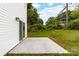 Back patio area with siding and door, ideal for outdoor entertaining and relaxation at 600 Legrand St, Shelby, NC 28150