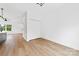 Bedroom with light wood flooring, ceiling fan and view into the kitchen at 600 Legrand St, Shelby, NC 28150