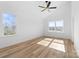 Bright bedroom with hardwood floors, ceiling fan, and two windows providing natural light at 600 Legrand St, Shelby, NC 28150