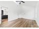 Bedroom with wood-look floors, neutral walls, a ceiling fan, and an en suite bathroom at 600 Legrand St, Shelby, NC 28150