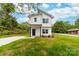 Charming two-story home featuring a crisp white exterior, black accents, and a well-manicured lawn at 600 Legrand St, Shelby, NC 28150