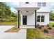 Inviting front porch with black support beams, a dark door, and tasteful landscaping at 600 Legrand St, Shelby, NC 28150