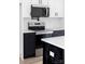 Modern kitchen featuring stainless steel appliances, white backsplash, black hardware, and white countertops at 600 Legrand St, Shelby, NC 28150