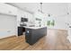 Open kitchen with black island, updated appliances, and abundant white cabinetry at 600 Legrand St, Shelby, NC 28150