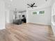 Bright and open living room with modern flooring, a ceiling fan, and views into the kitchen at 600 Legrand St, Shelby, NC 28150