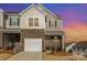 Two-story townhome with brick and siding, featuring a single-car garage and cozy front porch at 6048 Chelsea Oaks Rdg, Tega Cay, SC 29708