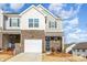Charming two-story brick and shingle home with a white garage door, blue door, and well-maintained landscaping at 6048 Chelsea Oaks Rdg, Tega Cay, SC 29708