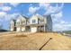Newly built townhomes with mixed brick and siding and a one-car garage at 6048 Chelsea Oaks Rdg, Tega Cay, SC 29708