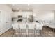 Bright, modern kitchen with stainless steel appliances, an island with bar seating, and seamless connection to the living area at 6048 Chelsea Oaks Rdg, Tega Cay, SC 29708