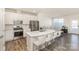 Bright, modern kitchen with stainless steel appliances, an island with bar seating, and seamless connection to the living area at 6048 Chelsea Oaks Rdg, Tega Cay, SC 29708