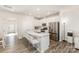 Bright, modern kitchen with stainless steel appliances, an island with bar seating, and seamless connection to the living area at 6048 Chelsea Oaks Rdg, Tega Cay, SC 29708
