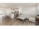 Open-concept living room flowing into a modern kitchen with a large, comfortable sectional sofa at 6048 Chelsea Oaks Rdg, Tega Cay, SC 29708