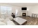 Bright living room boasts a fireplace, hardwood floors, and ample seating at 6048 Chelsea Oaks Rdg, Tega Cay, SC 29708