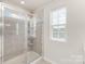 Modern bathroom shower with glass door and tiled walls at 6048 Chelsea Oaks Rdg, Tega Cay, SC 29708