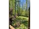View of backyard with mature trees, grassy lawn, and chain link fence at 705 Sagrada Dr, York, SC 29745