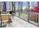 Spacious outdoor deck with seating area, grill, and scenic views of the surrounding trees at 705 Sagrada Dr, York, SC 29745