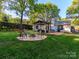 Spacious backyard features lush lawn, patio, fire pit, and charming gazebo at 7417 Shadowlake Dr, Charlotte, NC 28226