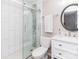 Bathroom with white-tiled shower, mosaic accent, toilet, and vanity with sink at 7417 Shadowlake Dr, Charlotte, NC 28226