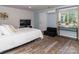 Bright bedroom with window, door to the outside, laminate flooring and neutral decor at 7417 Shadowlake Dr, Charlotte, NC 28226