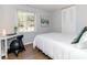 Bedroom with a large window, white bedding, a desk, and wood flooring at 7417 Shadowlake Dr, Charlotte, NC 28226