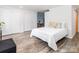 Neutral bedroom featuring laminate flooring, a closet, and a view to dining area at 7417 Shadowlake Dr, Charlotte, NC 28226