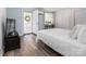 Bright bedroom featuring wood floors, a closet, an exterior door, and a mounted television at 7417 Shadowlake Dr, Charlotte, NC 28226