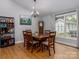 Formal dining room boasting hardwood floors, a chandelier, and ample natural light at 7417 Shadowlake Dr, Charlotte, NC 28226