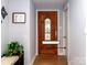 Home entryway with wood door leading to bonus room, hardwood floors, and decor at 7417 Shadowlake Dr, Charlotte, NC 28226