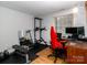 Flex room featuring exercise equipment and an office area with wood laminate flooring at 7417 Shadowlake Dr, Charlotte, NC 28226