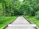 Wooden boardwalk winding through a lush greenway, soon to connect to the community at 7417 Shadowlake Dr, Charlotte, NC 28226