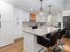 Updated kitchen featuring bright cabinets, a central island with barstool seating, and modern appliances at 7417 Shadowlake Dr, Charlotte, NC 28226