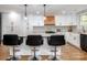 Bright kitchen with white cabinets, modern appliances, stone countertops, and stylish backsplash at 7417 Shadowlake Dr, Charlotte, NC 28226