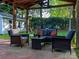 Inviting covered patio features comfortable seating, ceiling fan, and stylish decor at 7417 Shadowlake Dr, Charlotte, NC 28226