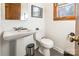 Traditional bathroom with white pedestal sink, toilet, dark framed mirror and natural light at 764 Hawthorne Ln, Rock Hill, SC 29730