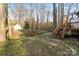 Large backyard featuring a wooden bridge, mature trees, and a shed on the property at 8220 Terra Linda Ln, Charlotte, NC 28215