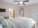 Sunlit bedroom with a ceiling fan, leading to a separate bathroom for convenience at 8220 Terra Linda Ln, Charlotte, NC 28215